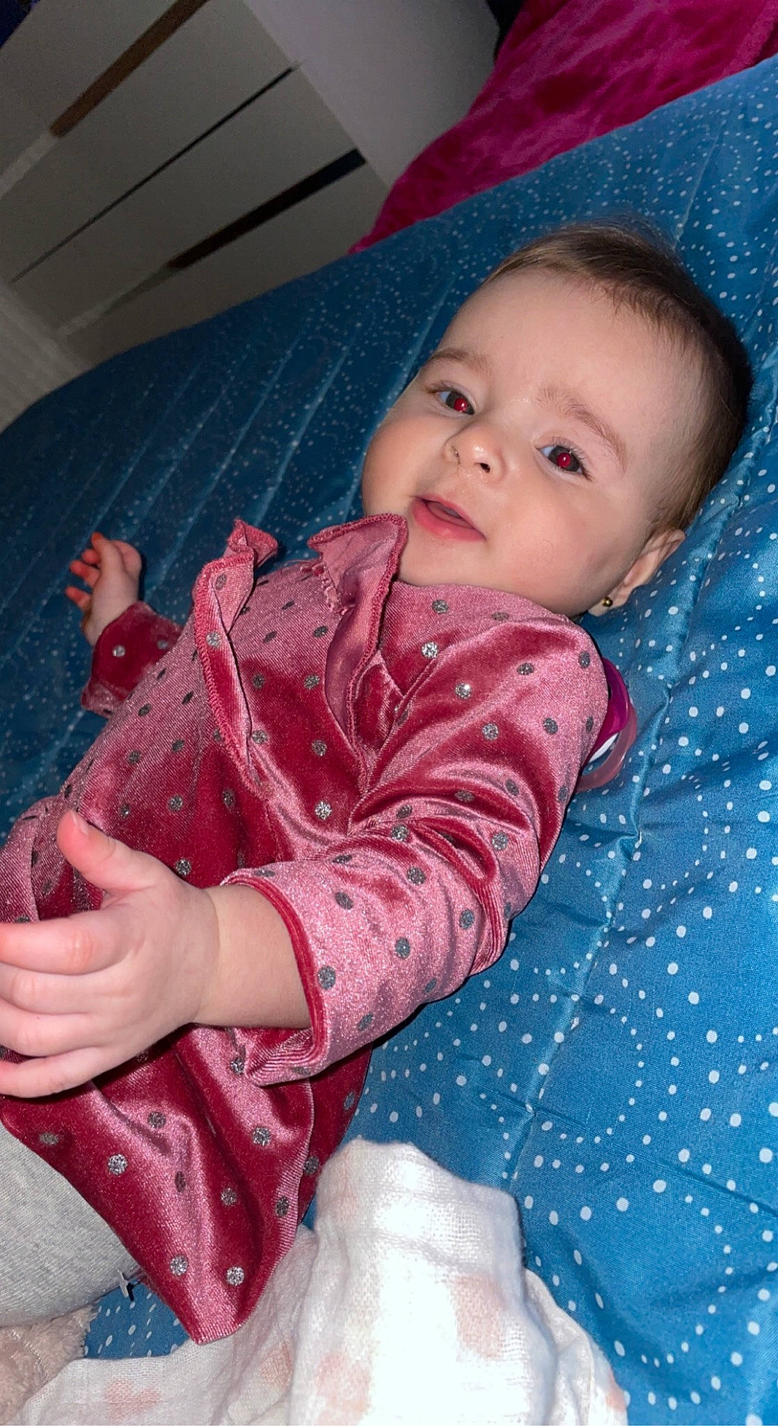 Shirine participe au concours pour gagner de l'argent avec cette photo : baby, baby_toddler_clothing, blue, cheek, child, comfort, finger, iris, lap, linens, lip, organ, pattern, person, pink, purple, red, skin, sleeve, smile