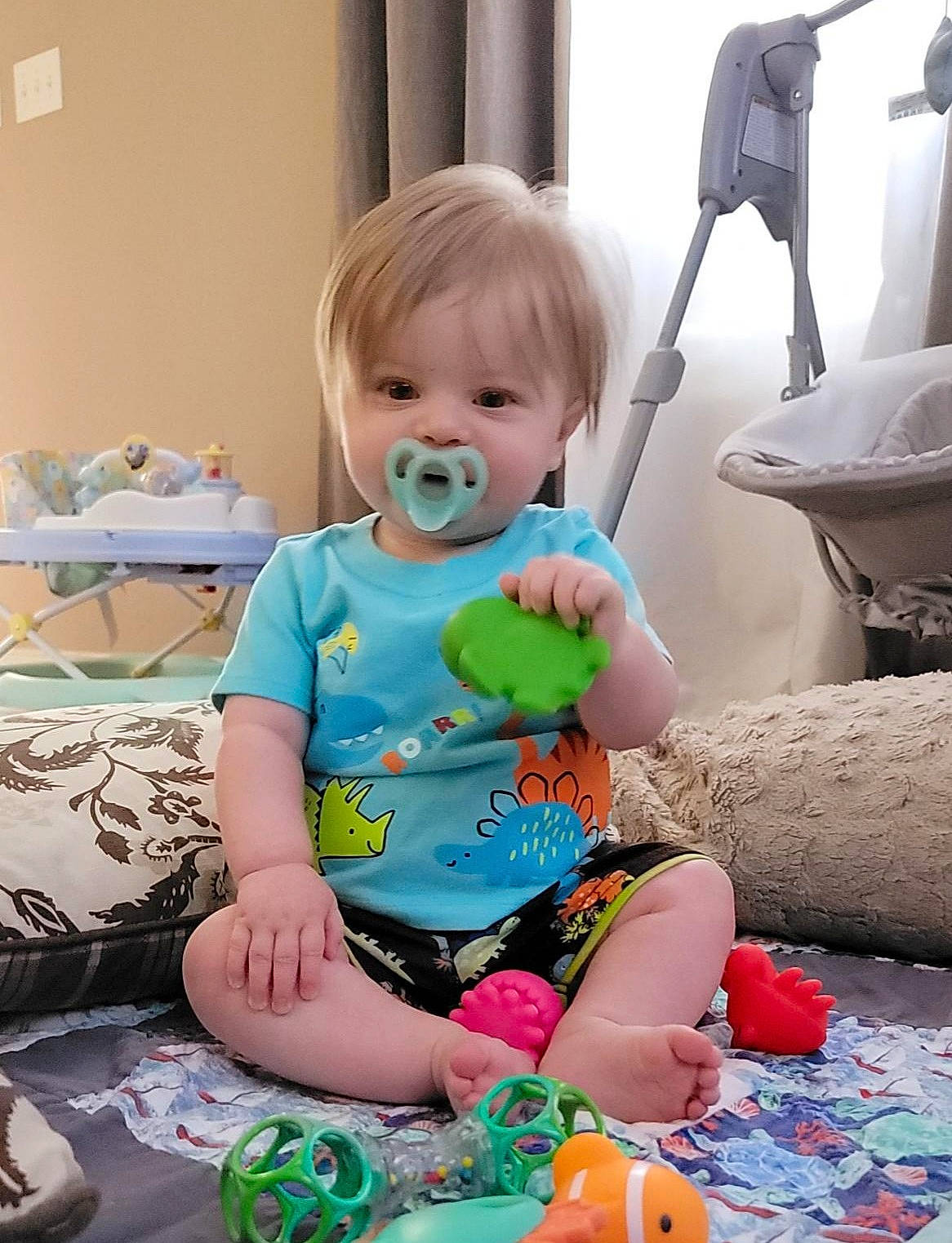 Kylen is registered to the contest to win money with this photo: baby, baby_products, baby_toddler_clothing, child, comfort, event, flooring, fun, happy, leisure, pattern, people, person, play, room, sitting, sleeve, t_shirt, thigh, toddler