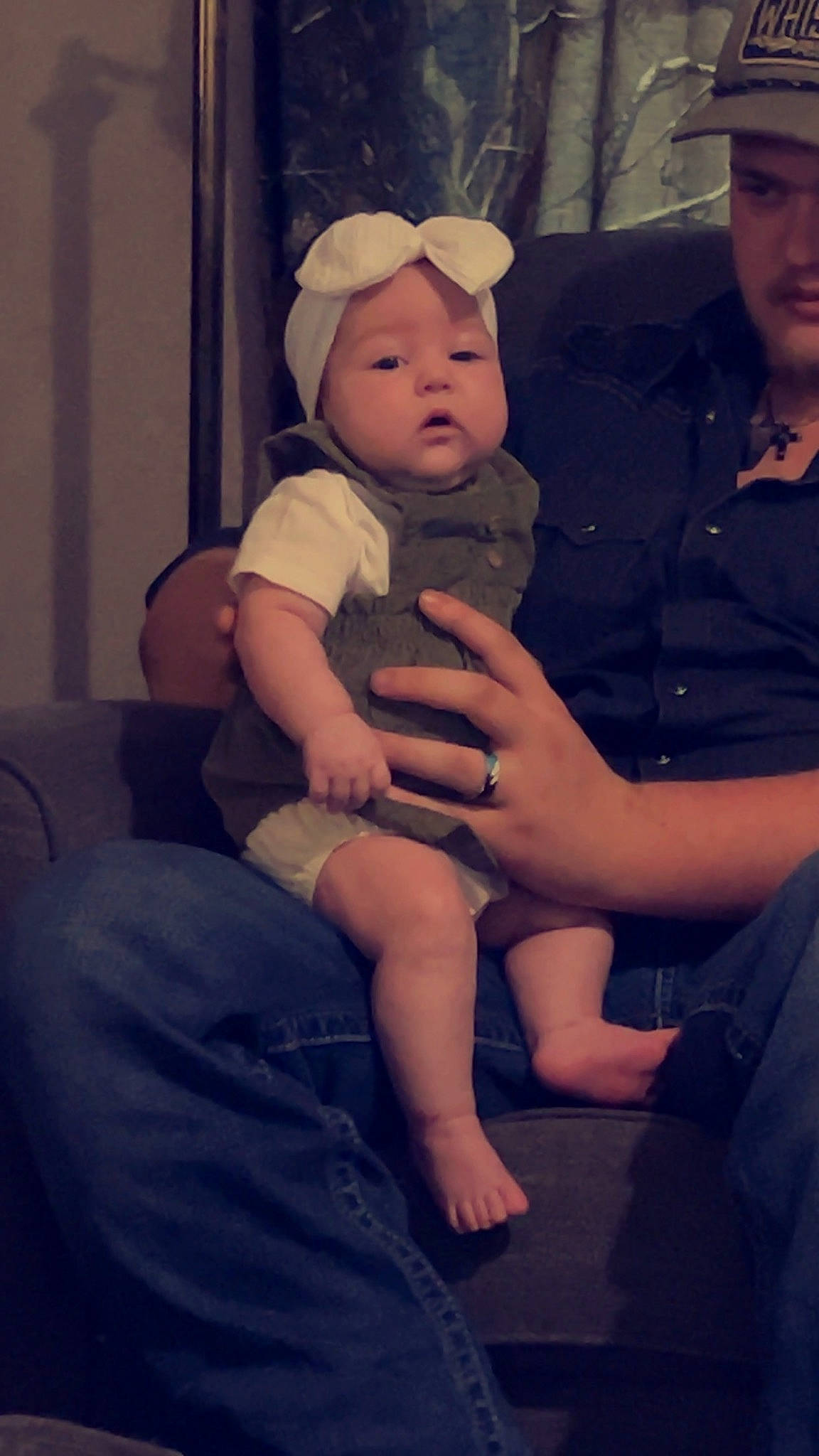 Kinleigh is registered to the contest to win money with this photo: baby, baby_toddler_clothing, baseball_cap, cap, child, event, flash_photography, foot, fun, gesture, happy, hat, headwear, human_leg, jewellery, lap, person, sitting, sun_hat, thigh