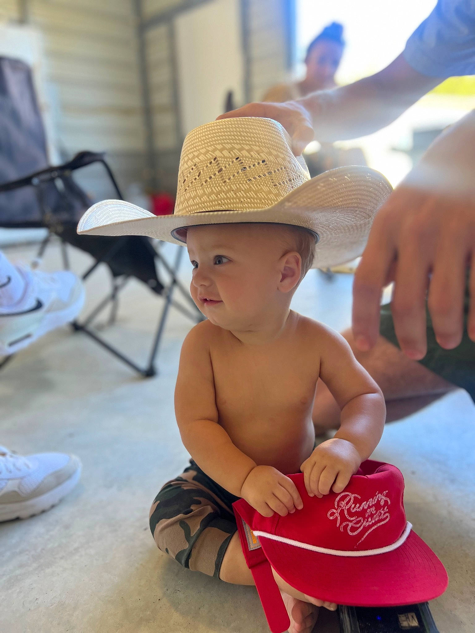 River joined the competition — help win amazing prizes! baby, cap, chair, child, fashion_accessory, fedora, flooring, foot, fun, hand, happy, hat, human_leg, leisure, nail, person, sitting, sun_hat, table, thigh