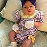 Blakely is registered to the contest to win money with this photo: baby, infant, purple_bow, mittens, socks, pillow, blanket, clothing, cute, lying_down, patterned_outfit, indoor, face, headband, newborn, adorable, soft_texture, resting, small_hands, young_child