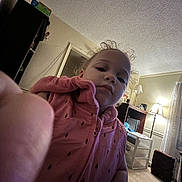 Miracle joined the competition — help win amazing prizes! toddler, child, indoor, vest, pink_clothing, curly_hair, face, finger, living_room, lamp, furniture, carpet, curtains, cabinet, drawer, home, person, portrait, casual, cozy