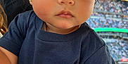 Raiden joined the competition — help win amazing prizes! toddler, child, face, person, clothing, tshirt, stadium, crowd, sports, event, earrings, hair, expression, side_view, young_child, indoor, lighting, portrait, casual, spectators
