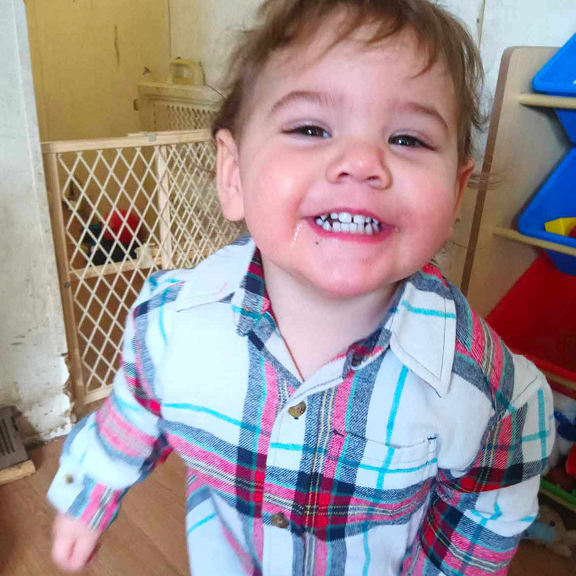 Cody is registered to the contest to win money with this photo: baby, blouse, bodypart, clothing, door, face, furniture, happy, head, indoors, jeans, laughing, mouth, pants, person, photography, portrait, shirt, smile, teeth