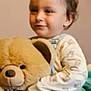 baby, blanket, child, childhood, clothing, cuddly, cute, face, happy, hugging, indoor, overalls, plush_toy, portrait, smiling, soft_toy, teddy_bear, toddler, toy, young