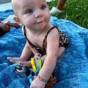 Kalayah joined the competition — help win amazing prizes! baby, child, outdoor, grass, blanket, toy, blue_blanket, sitting, curious, person, grass_lawn, playing, infant, jewelry, bracelet, earrings, summer, daylight, cute, young_child