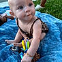 baby, child, outdoor, grass, blanket, toy, blue_blanket, sitting, curious, person, grass_lawn, playing, infant, jewelry, bracelet, earrings, summer, daylight, cute, young_child