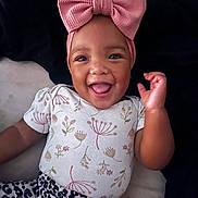 Katara joined the competition — help win amazing prizes! baby, child, smiling, headband, pink_bow, floral_shirt, leopard_print, tongue_out, happy, cute, portrait, infant, clothing, lying_down, dark_background, closeup, person, baby_fashion, playful, adorable