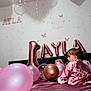 baby, birthday, balloon, pink, child, celebration, party, robe, bed, decor, room, face, hair, sitting, number_one, foil_balloon, butterfly_sticker, soft_toys, cute, indoors