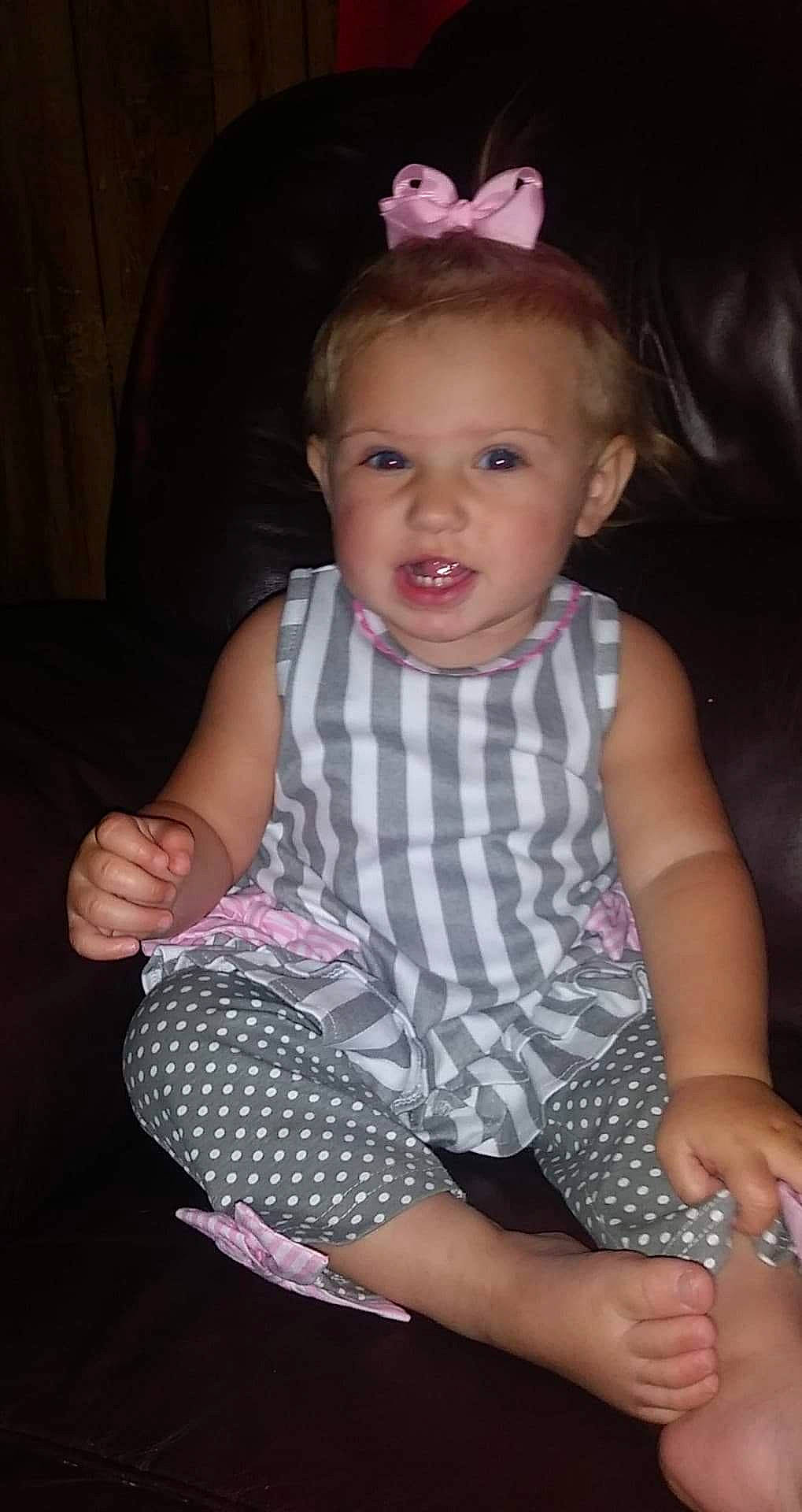 Serenity is registered to the contest to win money with this photo: arm, baby_toddler_clothing, black, cheek, eye, finger, hand, head, human_body, iris, leg, lip, mammal, neck, organ, person, product, skin, sleeve, textile