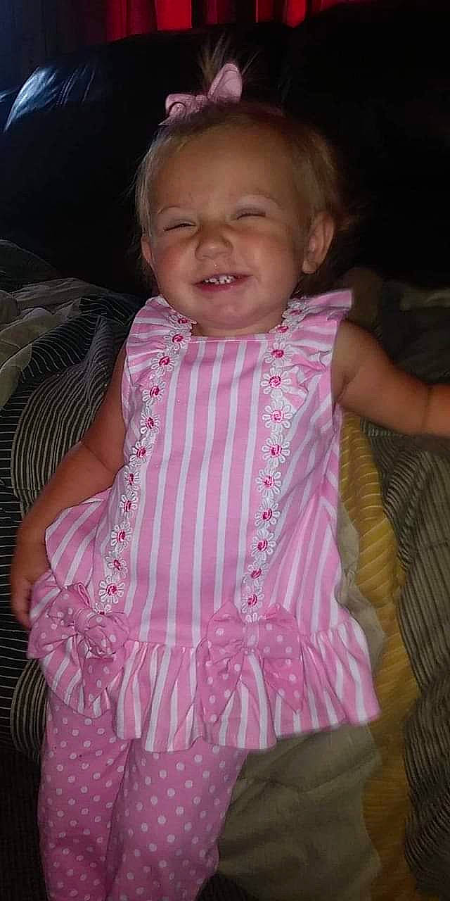 Serenity is registered to the contest to win money with this photo: baby, baby_toddler_clothing, cheek, child, comfort, eye, finger, forehead, happy, iris, joy, lip, magenta, nose, person, pink, purple, skin, sleeve, smile