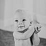 baby, child, infant, smile, clapping, hands, indoor, black_and_white, cute, happy, portrait, young, playful, expression, sitting, face, eyes, skin, hair, toddler