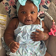 Kylani joined the competition — help win amazing prizes! baby, infant, child, blue_bow, headband, dress, floral_pattern, bracelet, pacifier, baby_seat, comfort, cute, adorable, portrait, smiling, happy, indoor, closeup, skin, person