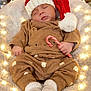 baby, sleeping, santa_hat, candy_cane, brown_outfit, bear_prints, cozy, blanket, fairy_lights, soft_texture, infant, cute, holiday, christmas, festive, warm_lighting, indoors, child, sleep, adorable