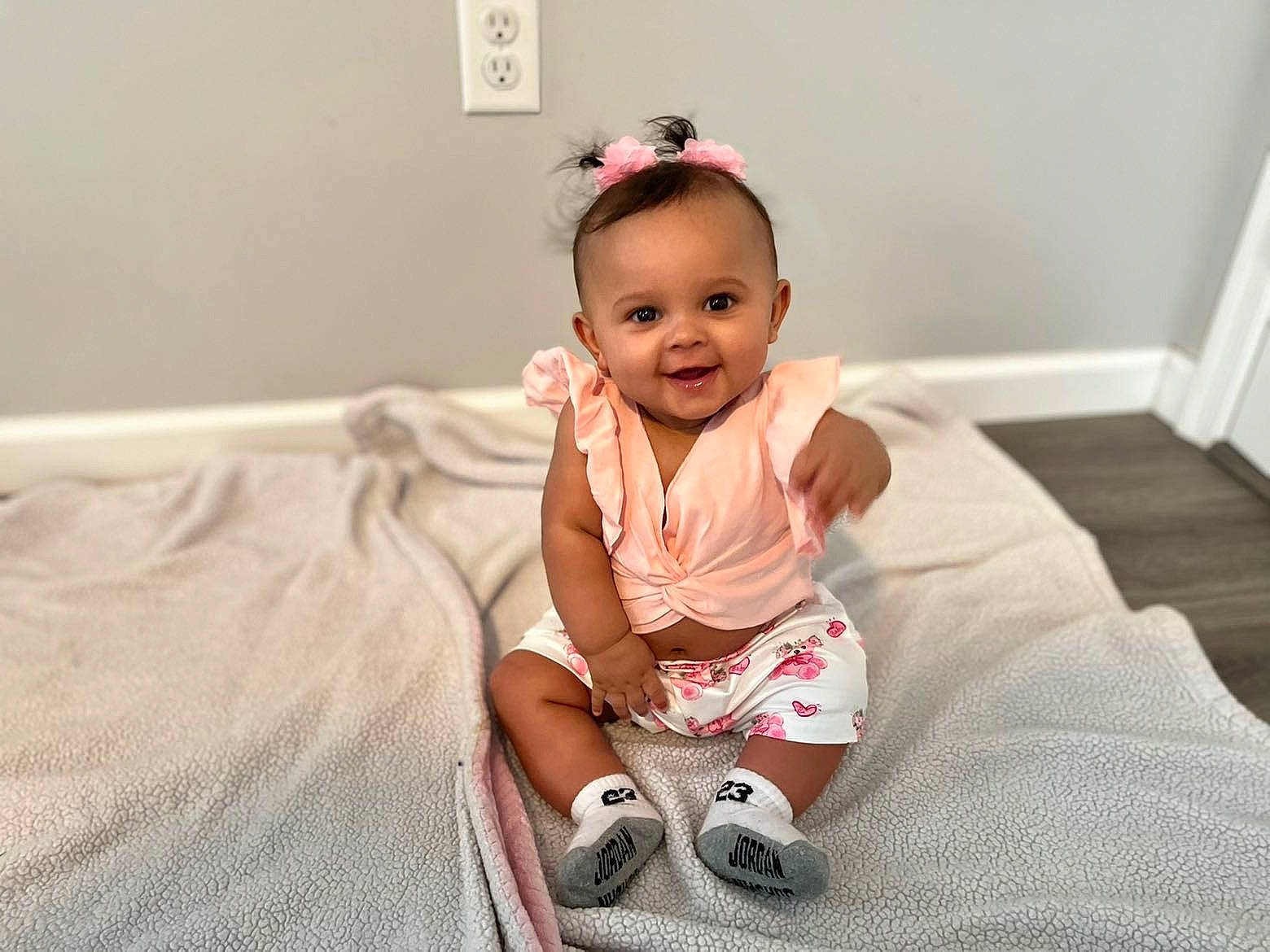 Aisa is registered to the contest to win money with this photo: baby, baby_toddler_clothing, cheek, child, comfort, eye, floor, flooring, fun, happy, human_leg, joy, knee, pattern, person, pink, sitting, skin, sleeve, smile