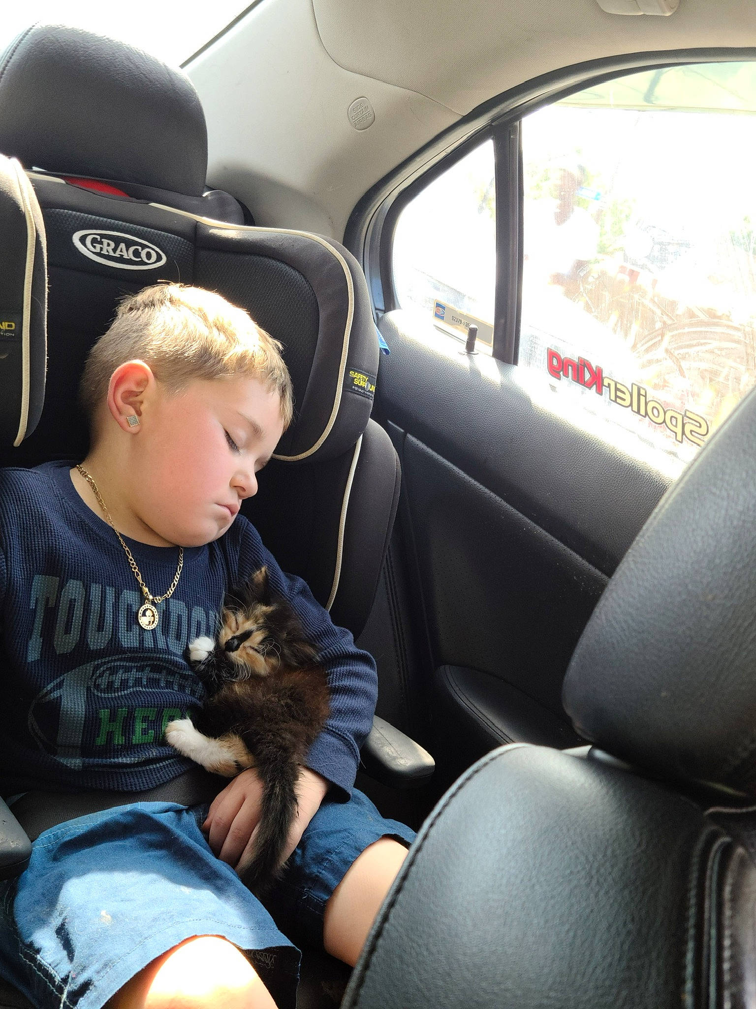 Dawson is registered to the contest to win money with this photo: auto_part, automotive_design, automotive_exterior, baseball_cap, car, car_seat, car_seat_cover, comfort, family_car, head_restraint, lap, motor_vehicle, person, personal_luxury_car, seat_belt, steering_part, steering_wheel, toddler, vehicle, vehicle_door