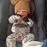 baby, car_seat, hat, pom_pom, onesie, pacifier, infant, child, clothing, seatbelt, transportation, cute, sleepy, warm, indoor, fabric, blanket, baby_accessory, headwear, sitting