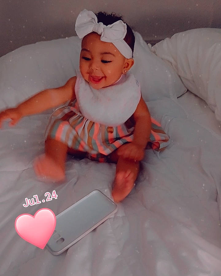 Kimora is registered to the contest to win money with this photo: baby, baby_products, baby_toddler_clothing, bathing, carmine, child, comfort, font, fun, gadget, hand, happy, headwear, linens, person, pink, sleeve, smile, textile, thumb