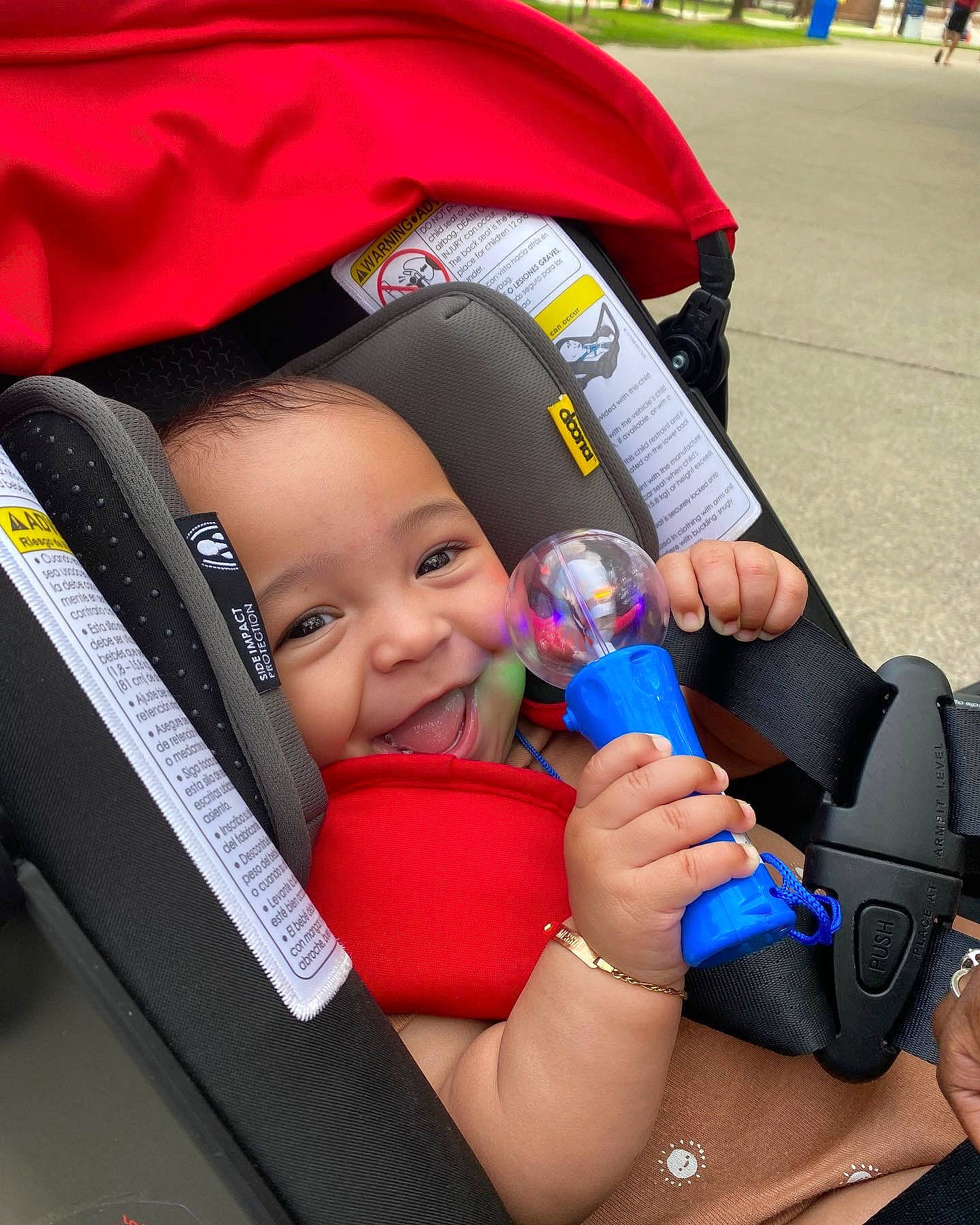 Messiah is registered to the contest to win money with this photo: baby, baby_carriage, baby_products, car_seat, child, face, facial_expression, finger, fun, gesture, hand, happy, human_body, joy, person, product, skin, smile, snapshot, thigh