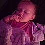 baby, sleeping, blanket, plush_toy, bunny, soft_texture, cozy, infant, peaceful, pink_clothing, child, indoors, portrait, relaxation, cute, hand_near_face, young_child, comfort, nighttime, warm