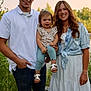 Oaklynn is registered to the contest to win money with this photo: family, man, woman, toddler, outdoor, smiling, happy, nature, greenery, sunset, casual_clothing, white_polo, denim_shirt, white_dress, sandals, portrait, people, grass, trees, daylight