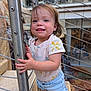 Oaklynn joined the competition — help win amazing prizes! toddler, child, smile, happy, outdoor, railing, clothing, denim_shorts, flower_pattern, person, metal, hand, face, hair, urban, background, stairs, railing_cables, skin, blue_eyes