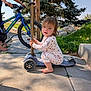 Oaklynn joined the competition — help win amazing prizes! toddler, child, scooter, bike, barefoot, sidewalk, outdoor, sunny, greenery, tree, grass, concrete, pajamas, play, person, young_child, vehicle, daylight, happy, casual