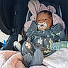 baby, blanket, bottle, car_seat, child, clothing, cozy, cute, face, floral_pattern, gray, indoors, infant, newborn, onesie, pacifier, person, pink, resting, sleepwear