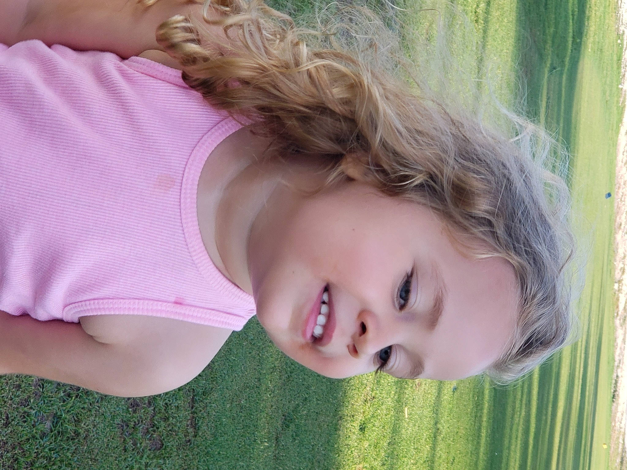 Alicia is registered to the contest to win money with this photo: bangs, brown_hair, eye, eyebrow, eyelash, flash_photography, grass, green, happy, iris, joy, lip, long_hair, nose, organ, people_in_nature, person, plant, skin, smile