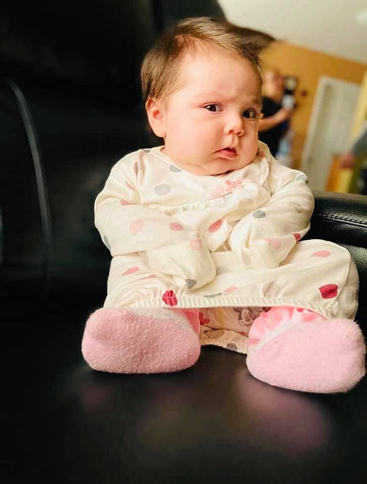 Mercedes is registered to the contest to win money with this photo: baby, baby_toddler_clothing, cheek, child, collar, comfort, face, flash_photography, floor, flooring, fun, happy, head, iris, person, portrait_photography, sitting, skin, sleeve, sock