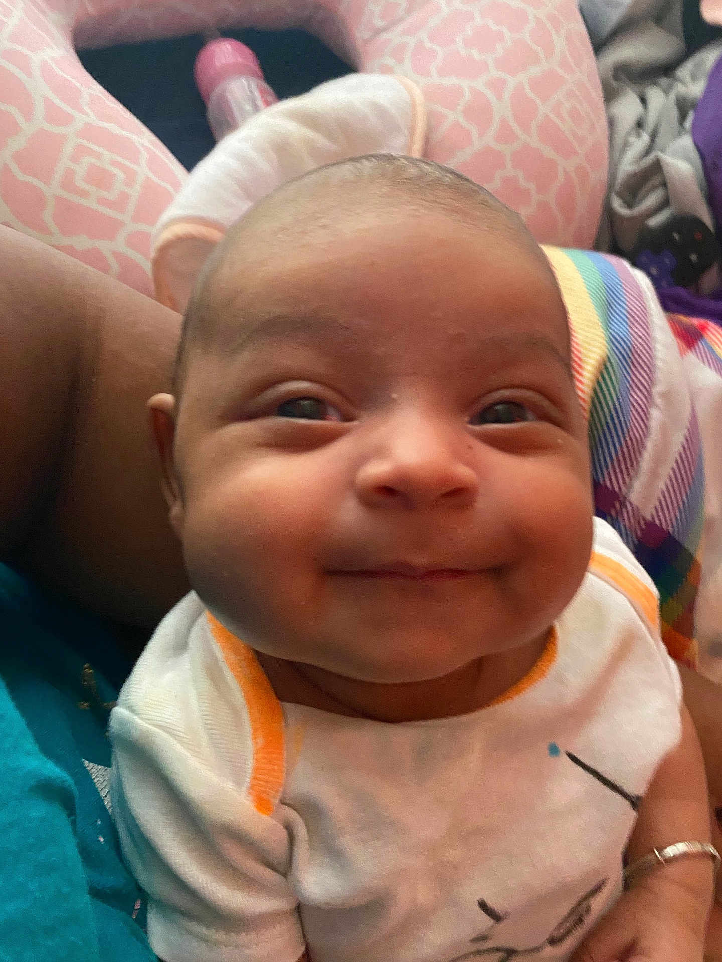 Nova joined the competition — help win amazing prizes! baby, smiling, face, infant, clothing, person, closeup, cute, portrait, happy, child, patterned_fabric, colorful, sitting, human, indoors, skin, arm, head, young
