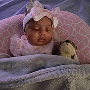 Nova is registered to the contest to win money with this photo: baby, sleeping, blanket, headband, bow, stuffed_animal, pink, soft, cozy, infant, child, cute, peaceful, tucked_in, plush, bedtime, portrait, indoors, clothing, resting