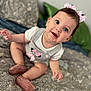 baby, child, smiling, sitting, indoor, bed, pillow, bow, footwear, clothing, person, cute, happy, face, blue_eyes, pattern, soft_focus, infant, pink, home