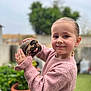Maëlyne participe au concours pour gagner de l'argent avec cette photo : child, turtle, pink_sweater, outdoor, garden, plant, pot, greenery, portrait, smile, animal, pet, cute, nature, person, young, holding, face, happy, background_blur