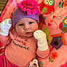 baby, infant, hat, mittens, pink, purple, playmat, owl, flower, pacifier, clothing, cute, child, portrait, smiling, indoor, colorful, happy, face, person