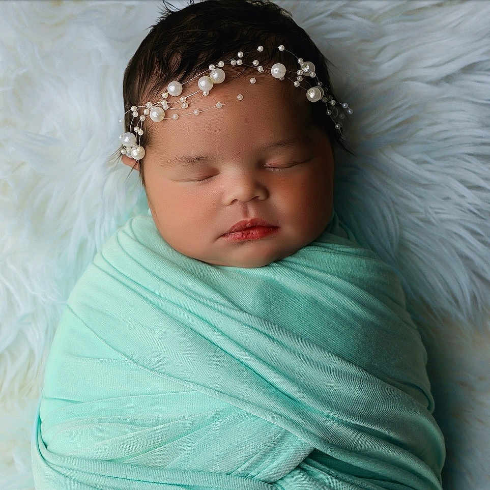 Riot is registered to the contest to win money with this photo: baby, blanket, child, closeup, cozy, cute, face, fur, headband, infant, mint_green, newborn, peaceful, pearl, portrait, resting, sleeping, soft, white, wrapped