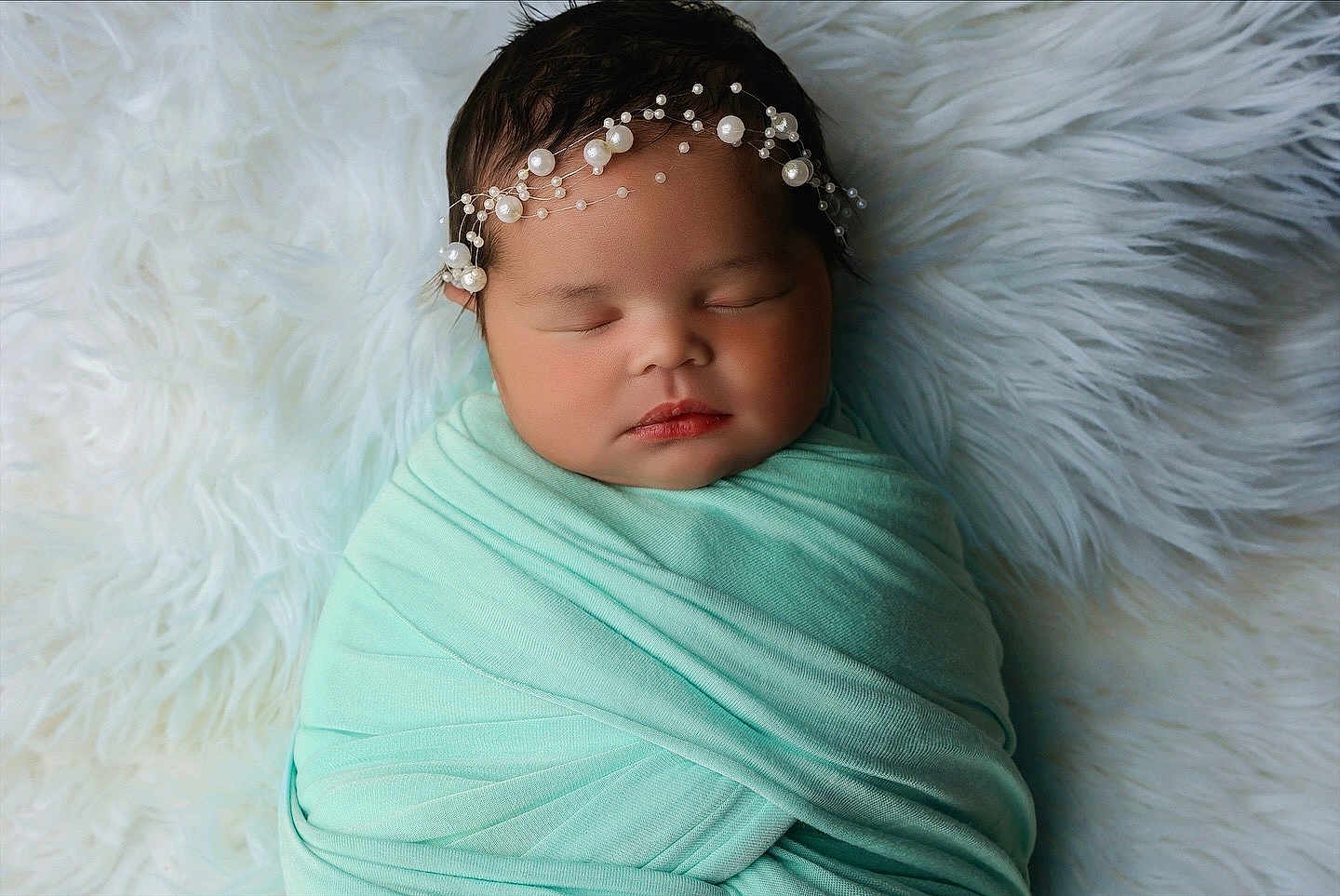 Riot is registered to the contest to win money with this photo: newborn, baby, sleeping, wrapped, blanket, headband, pearl, soft, mint_green, white, fur, cozy, portrait, infant, peaceful, cute, face, resting, child, closeup