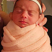 Kyliee is registered to the contest to win money with this photo: baby, newborn, swaddle, headband, bow, sleeping, closeup, infant, cozy, pink, hand_holding, blanket, face, eyes_closed, peaceful, skin, hair, nursery, portrait, fabric