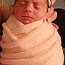 Kyliee joined the competition — help win amazing prizes! baby, newborn, infant, swaddle, blanket, headband, bow, sleeping, closed_eyes, hands, fingers, portrait, close_up, indoor, soft_texture, peach, skin, cute, cozy, parental_support