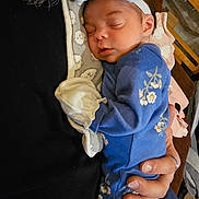 Kyliee joined the competition — help win amazing prizes! baby, newborn, sleeping, blue_onesie, bow_headband, hand, person, floral_pattern, infant, cute, peaceful, closeup, indoor, soft_lighting, toddler, sleep, human, portrait, cozy, cuddle