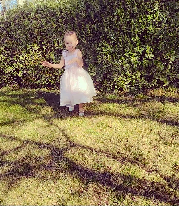 Emerie joined the competition — help win amazing prizes! baby, bridal_party_dress, child, day_dress, dress, fun, gesture, grass, grassland, happy, joy, meadow, one_piece_garment, pattern, people_in_nature, person, plant, prairie, sitting, tints_and_shades