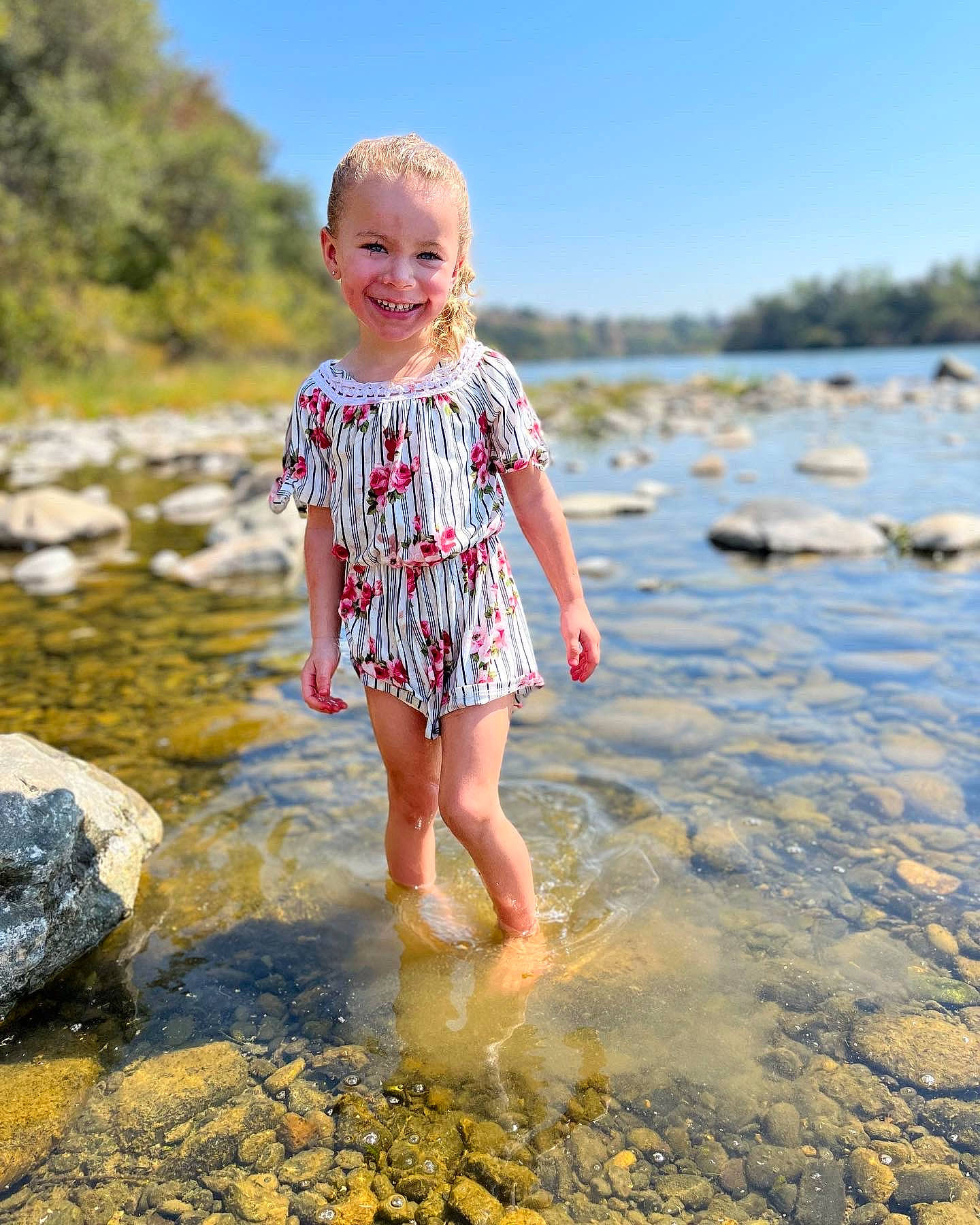 Emerie is registered to the contest to win money with this photo: baby_toddler_clothing, barefoot, beach, body_of_water, fun, happy, joy, lake, landscape, leisure, people_in_nature, people_on_beach, person, sand, shore, sky, smile, summer, sunlight, toddler