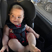 Avery is registered to the contest to win money with this photo: baby, car_seat, child, smile, red_clothing, safety_harness, car_interior, window, person, dog, sunlight, seatbelt, infant, cute, portrait, happy, casual, vehicle, human, side_view