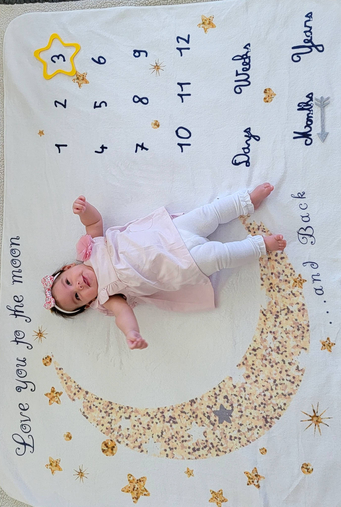 Grace is registered to the contest to win money with this photo: art, baby, baby_toddler_clothing, bedding, child, circle, comfort, font, gesture, happy, headwear, illustration, linens, paper, paper_product, pattern, person, product, sleeve, t_shirt