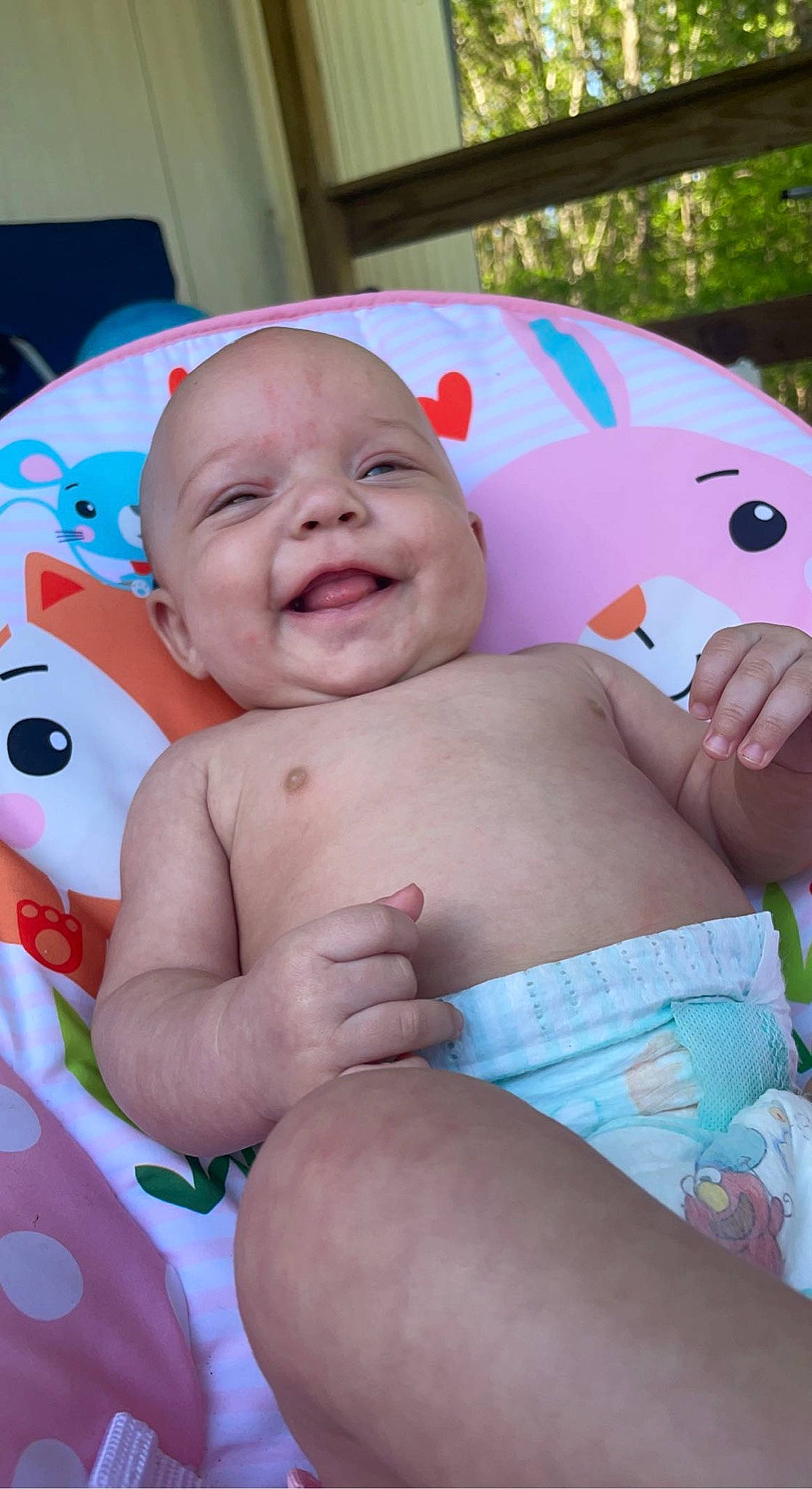 Oaklynn is registered to the contest to win money with this photo: abdomen, baby, cheek, child, comfort, facial_expression, finger, happy, interaction, leisure, mouth, muscle, nose, person, pink, skin, smile, stomach, textile, thigh