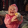 Stevie joined the competition — help win amazing prizes! baby, child, smiling, pink_clothing, headband, plush_toy, indoor, blanket, happy, seated, cute, infant, cozy, soft_toy, portrait, clothing, person, furniture, warm, home