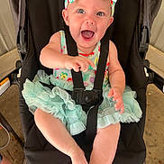 Elayna is registered to the contest to win money with this photo: baby, child, stroller, headband, dress, smiling, happy, infant, toddler, seatbelt, black, colorful, cute, outdoor, legs, arms, face, expression, joy, playful