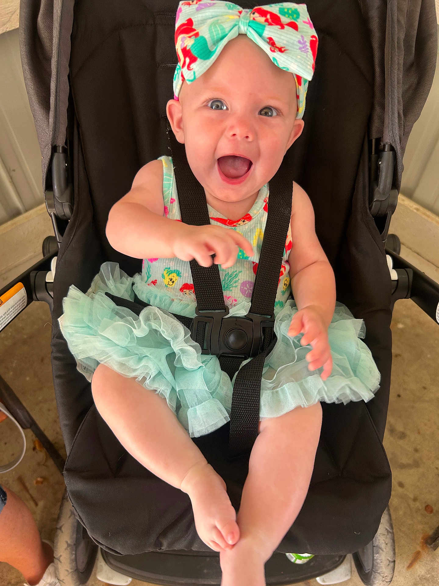 Elayna is registered to the contest to win money with this photo: baby, child, stroller, headband, dress, smiling, happy, infant, toddler, seatbelt, black, colorful, cute, outdoor, legs, arms, face, expression, joy, playful