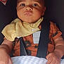 baby, infant, car_seat, bib, blanket, clothing, child, face, hands, seatbelt, cute, indoor, portrait, young_child, expression, comfort, wearing, sitting, closeup, skin