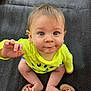 baby, child, infant, yellow_shirt, blue_shorts, barefoot, toes, red_nail_polish, feet, playful, curious, sitting, mat, texture, indoors, portrait, face, hand, eyes, expression